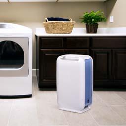Manufacturer photo of the Ivation IVADDH06 in a laundry room, extracted from its 2017 specification sheet.