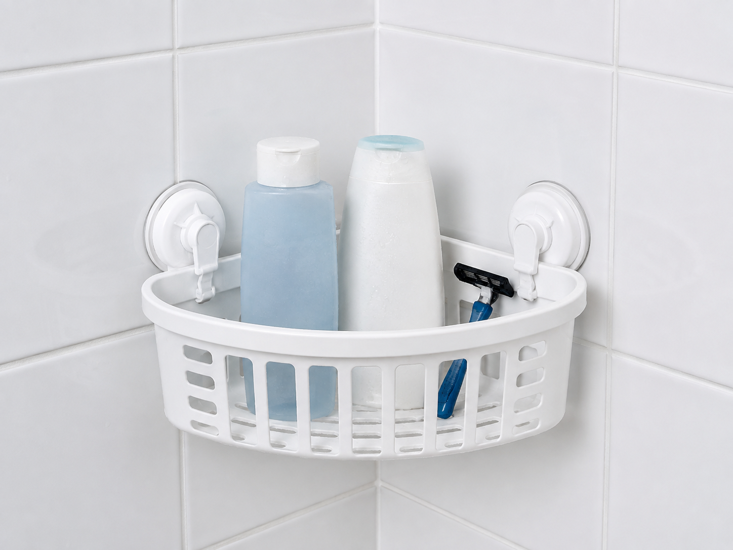 Original unbranded illustration of a white corner shower basket held to smooth gray tile by two lever suction mounts.