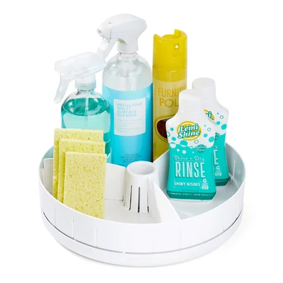 White YouCopia SinkSuite under-sink turntable loaded with cleaning bottles and sponges on a white background.