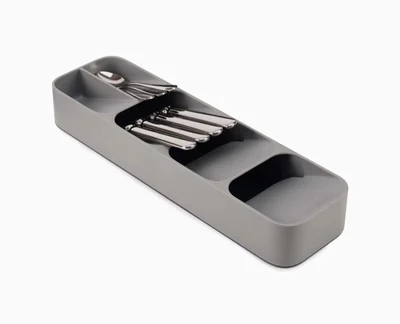Gray Joseph Joseph DrawerStore compact cutlery organizer SKU 85119 holding forks and spoons on a white background.