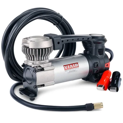 VIAIR 88P portable compressor with coiled air hose and red and black battery clamps on a white background.
